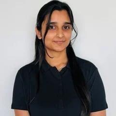 Portrait of a woman with long dark hair wearing a dark polo shirt against a white background