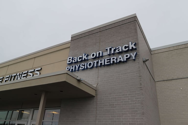 Storefront exterior showing Back on Track Physiotherapy sign on brick building with fitness center visible on left