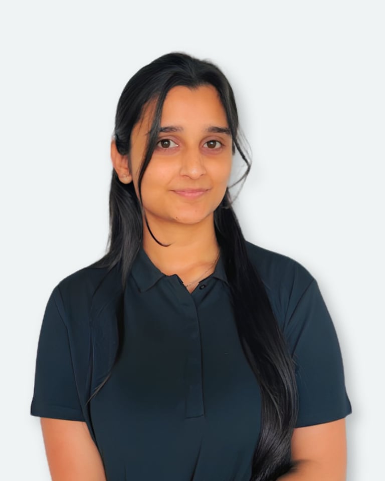 Portrait of a young woman with long black hair wearing a dark blue polo shirt against a white background