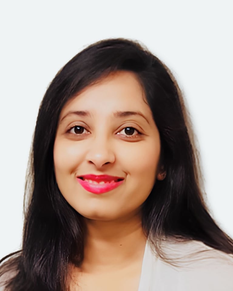 Portrait of a woman with long black hair and bright pink lipstick smiling at the camera against a white background